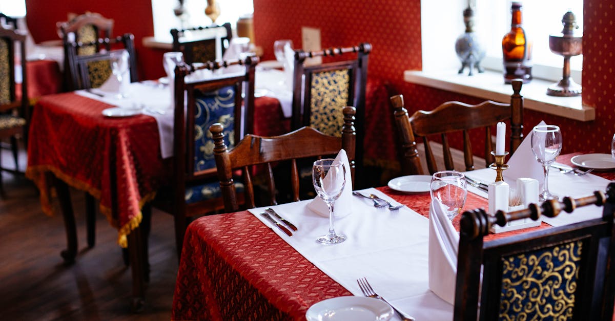 An elegant brasserie dining room with linen-topped tables and wine glasses