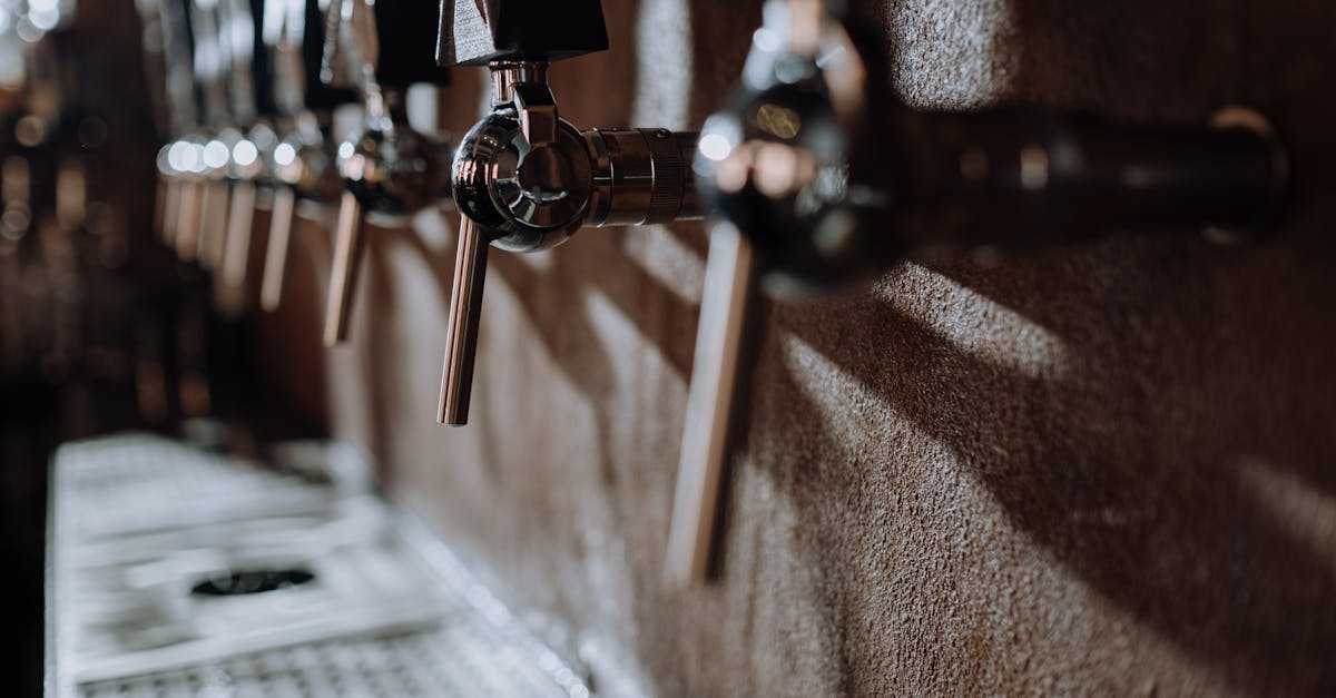 A row of beer taps along the bar of a craft brewery taproom