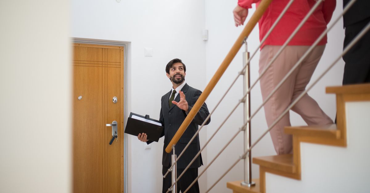 An estate agent showing buyers around a modern home