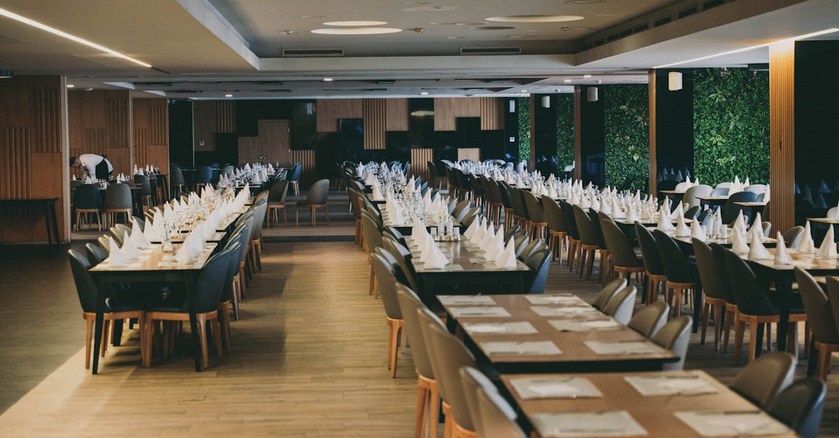 A spacious restaurant dining room with tables laid and ready for service