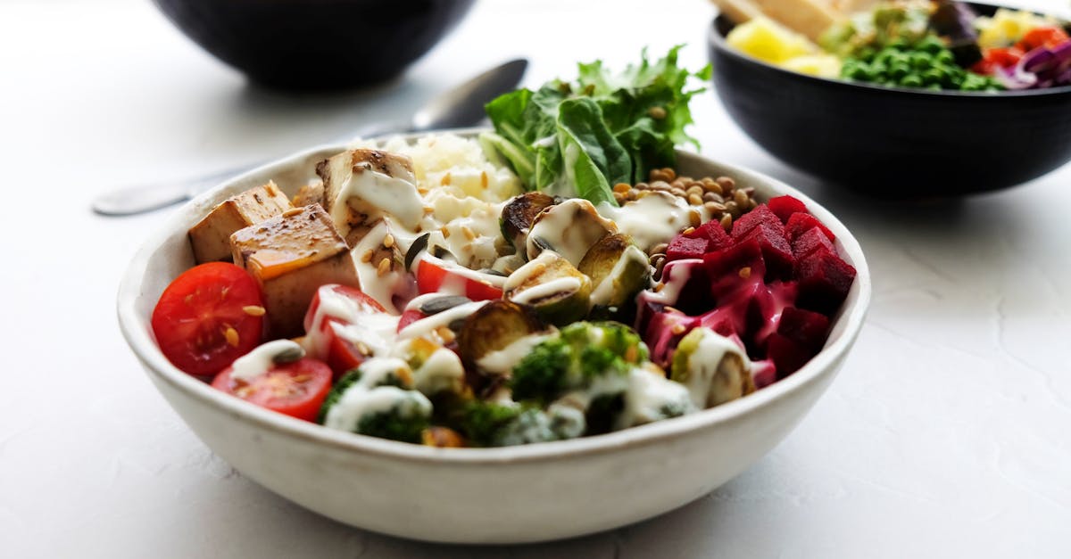 A vibrant plant-based Buddha bowl of fresh vegetables in a vegan restaurant
